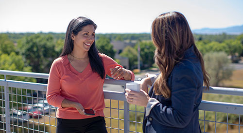 co-workers talking on a balcony